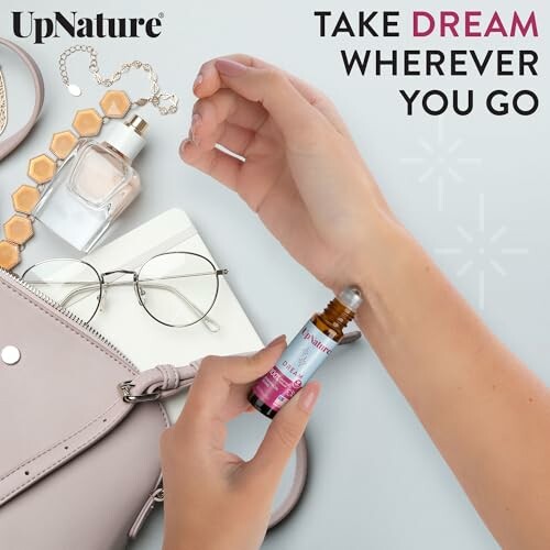 Person applying essential oil with accessories and bag nearby. Enjoying the soothing application of UpNature Dream Roll-On.